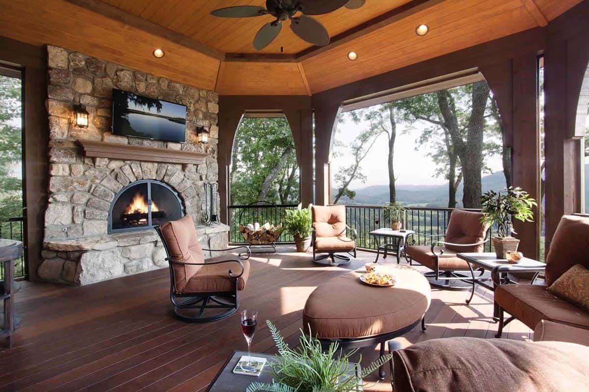 mountain rustic home exterior covered patio with a fireplace