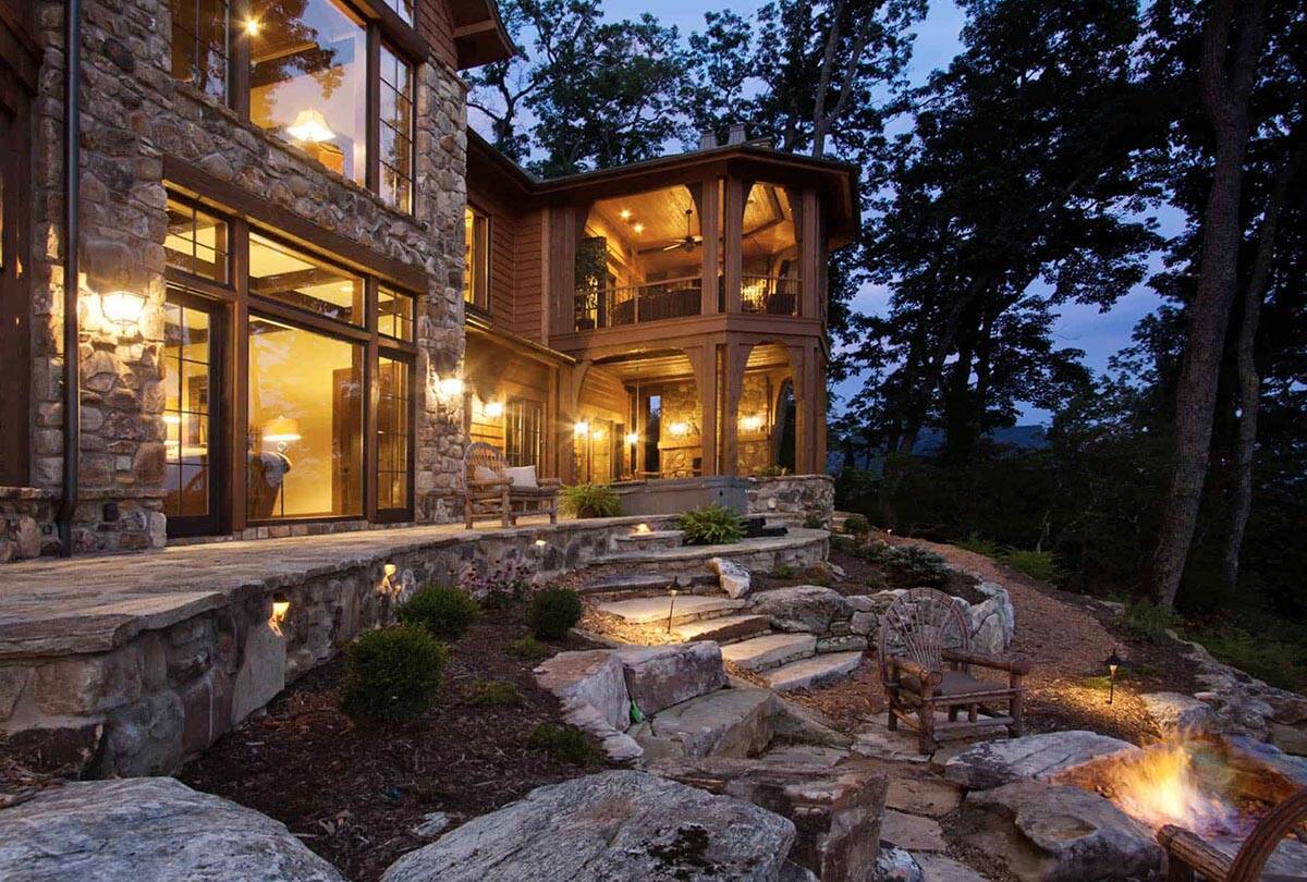 mountain rustic home exterior backyard view at dusk