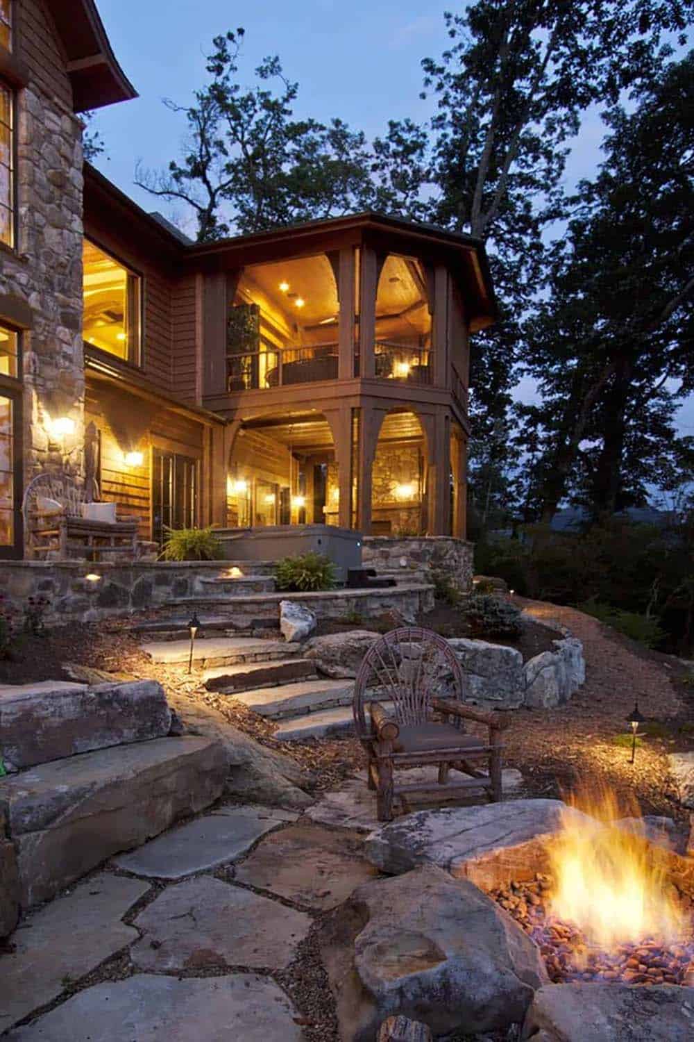 mountain rustic home exterior backyard with a fire pit at dusk