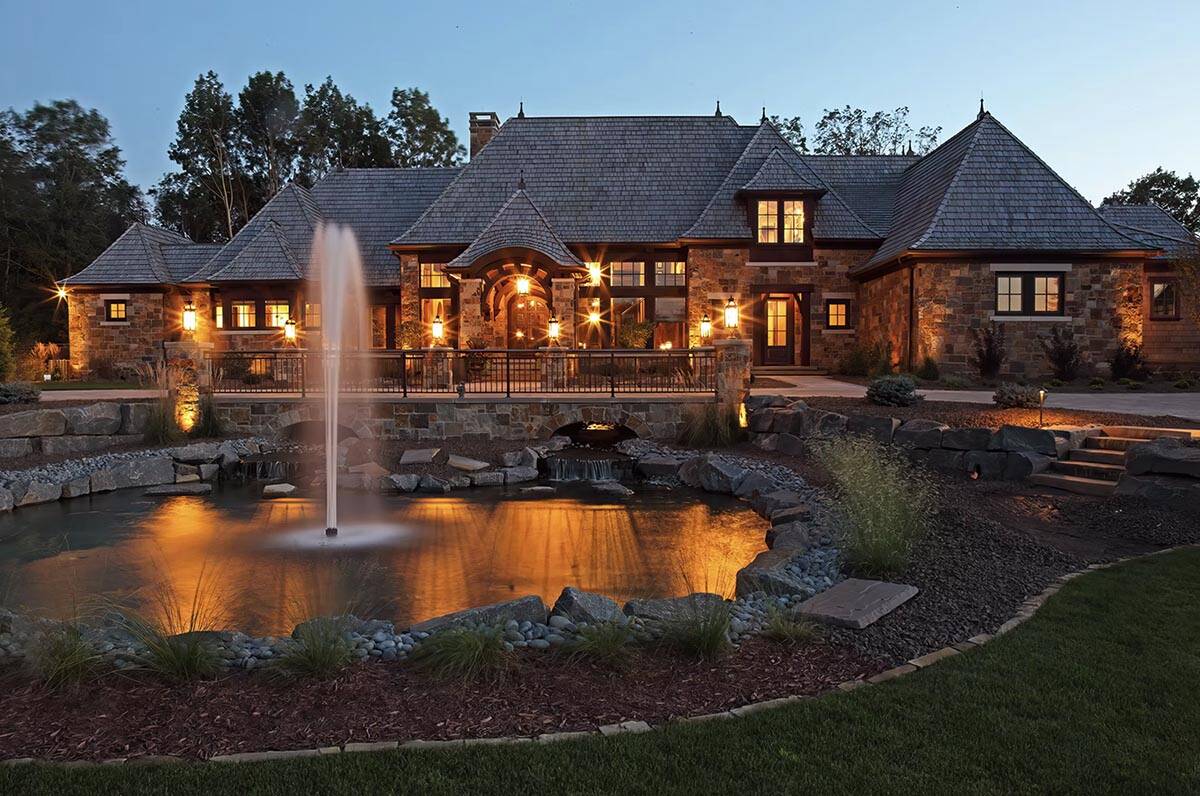 old world lodge style home exterior at dusk