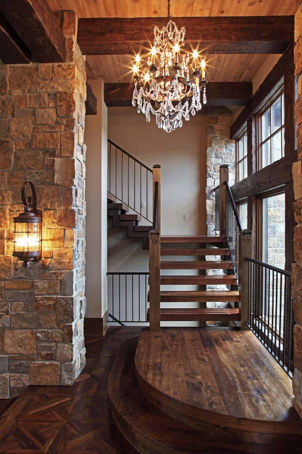 old world lodge style home entry with a staircase