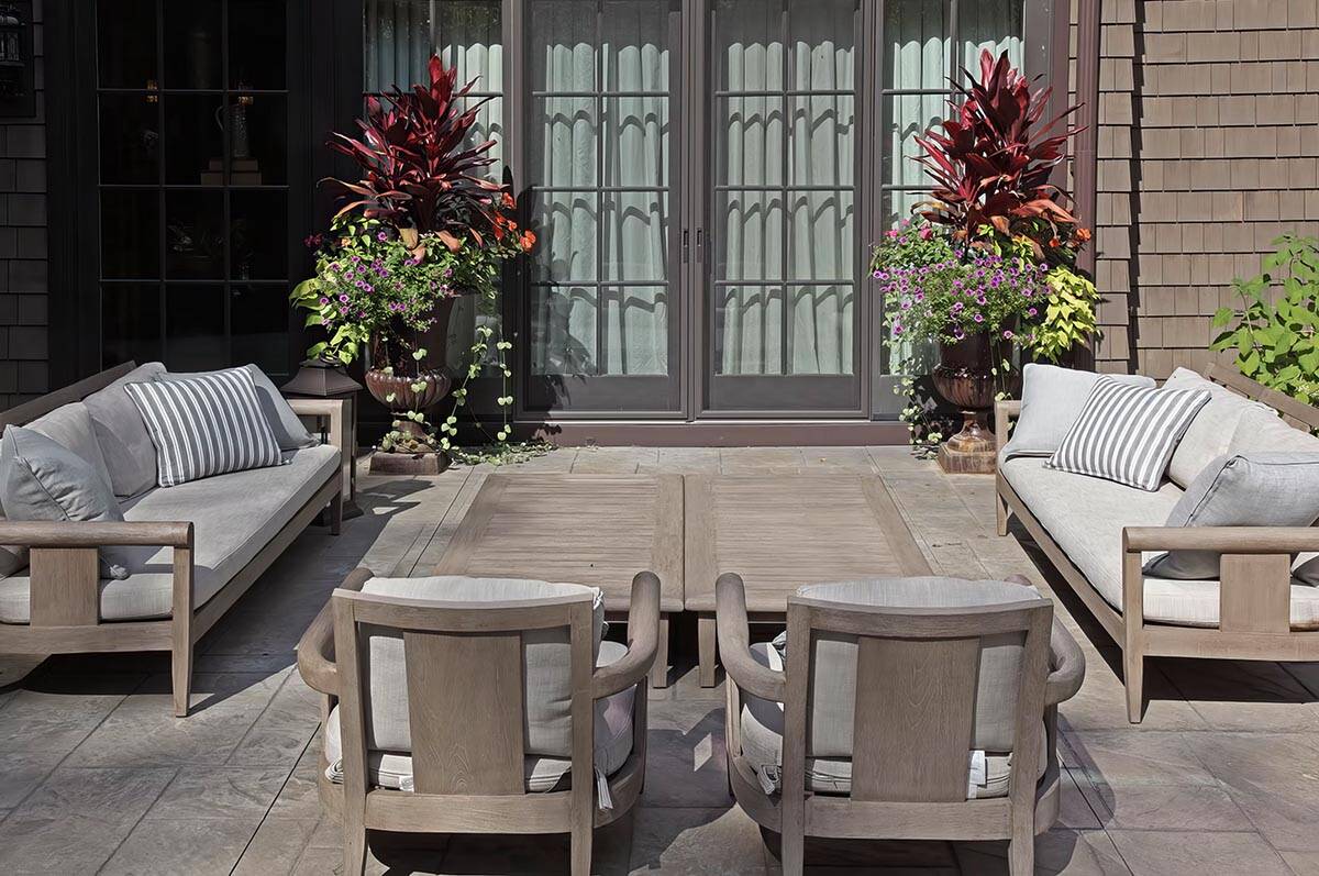 old world lodge style home exterior patio with outdoor furniture