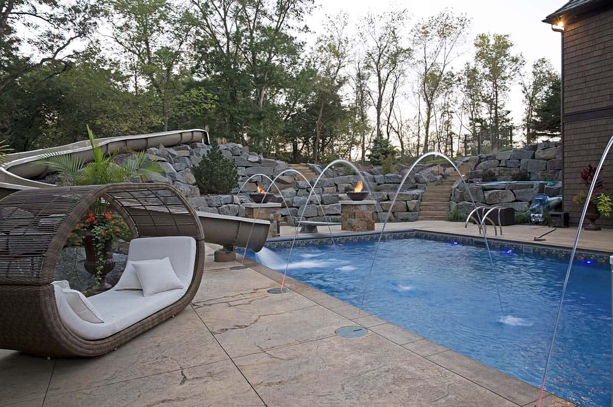 old world lodge style home exterior with a pool