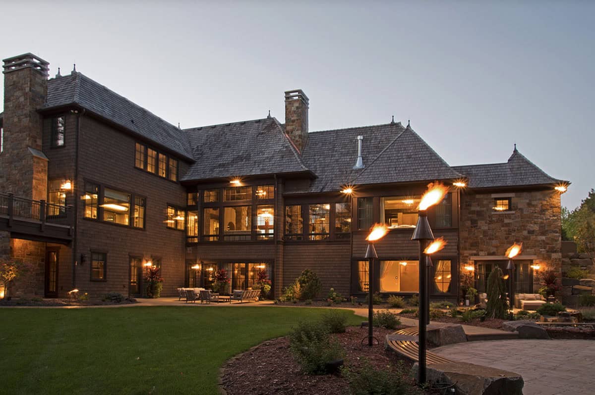 old world lodge style home exterior at dusk