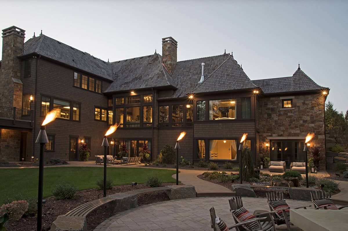 old world lodge style home exterior at dusk