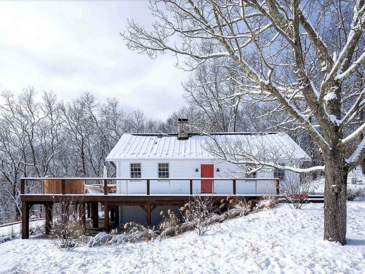 rustic cottage exterior with snow