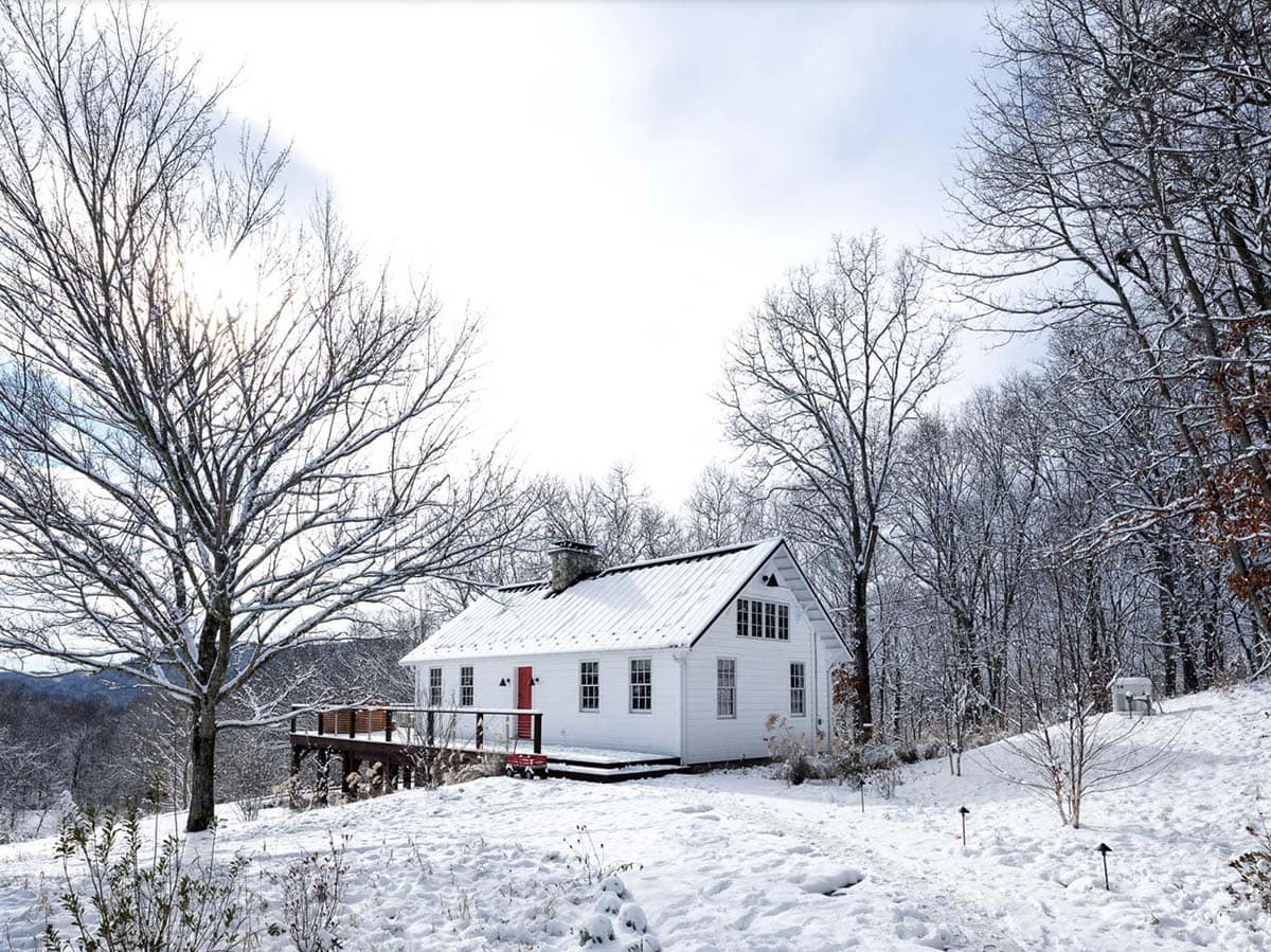 rustic cottage exterior with snow