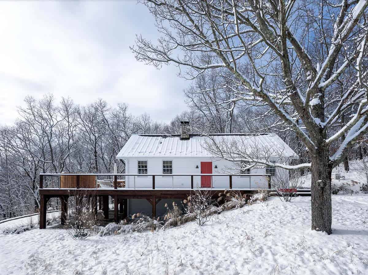 rustic cottage exterior with snow