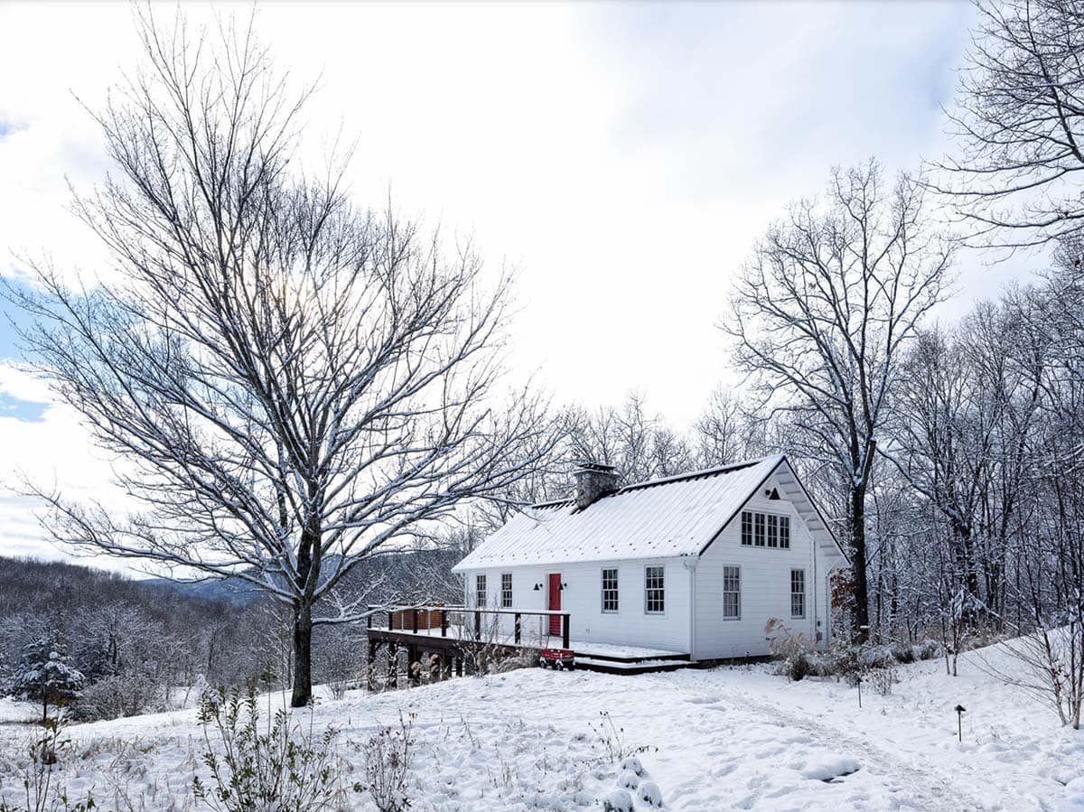 rustic cottage exterior with snow