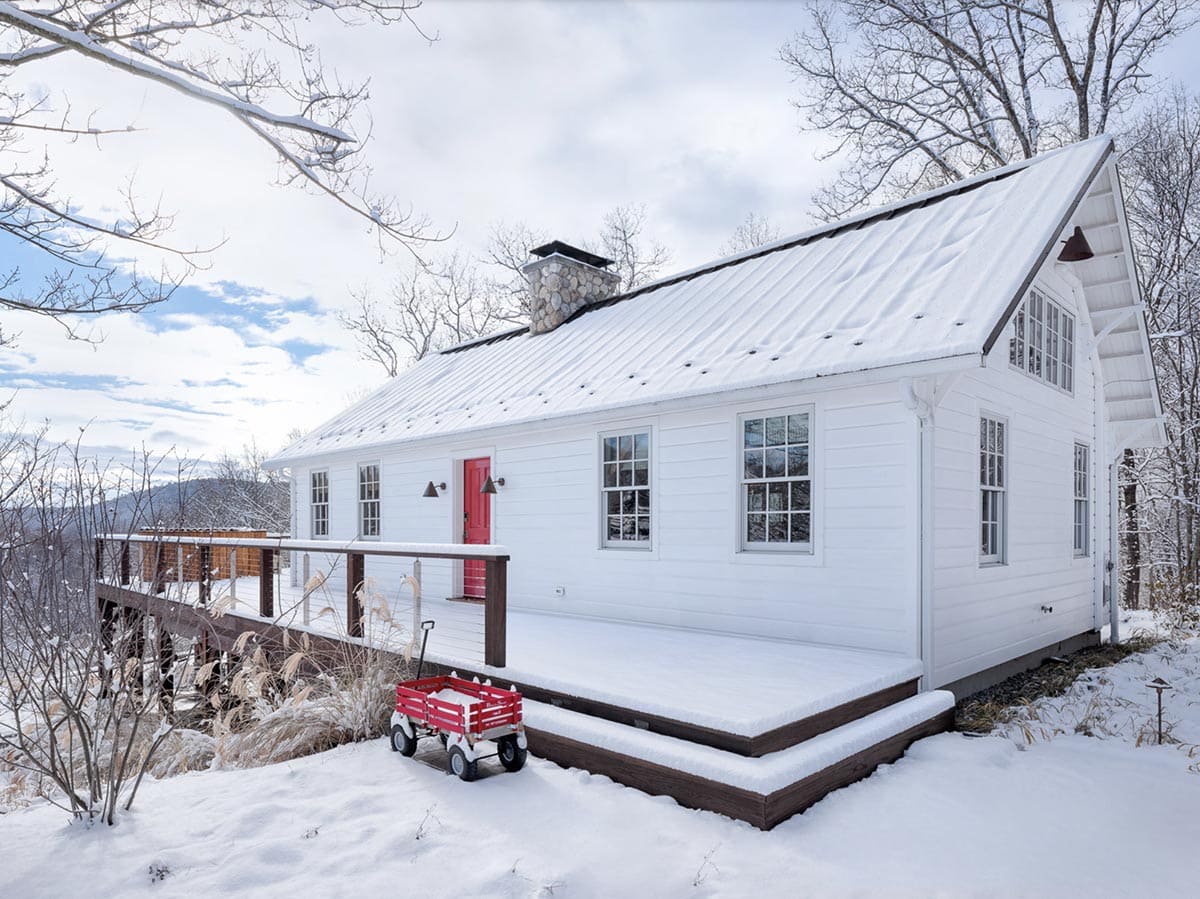 rustic cottage exterior with snow