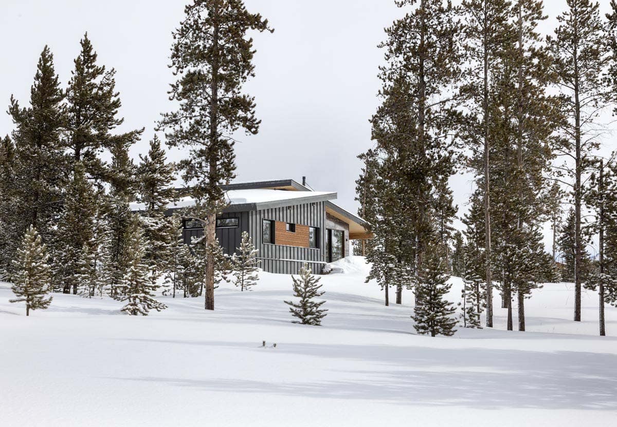modern mountain home exterior with snow