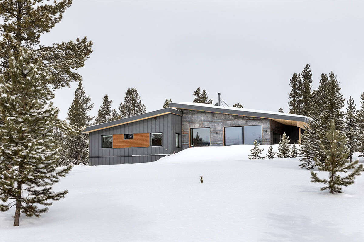 modern mountain home exterior with snow
