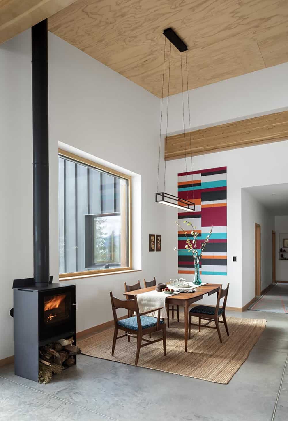 modern dining room with a wood fired stove