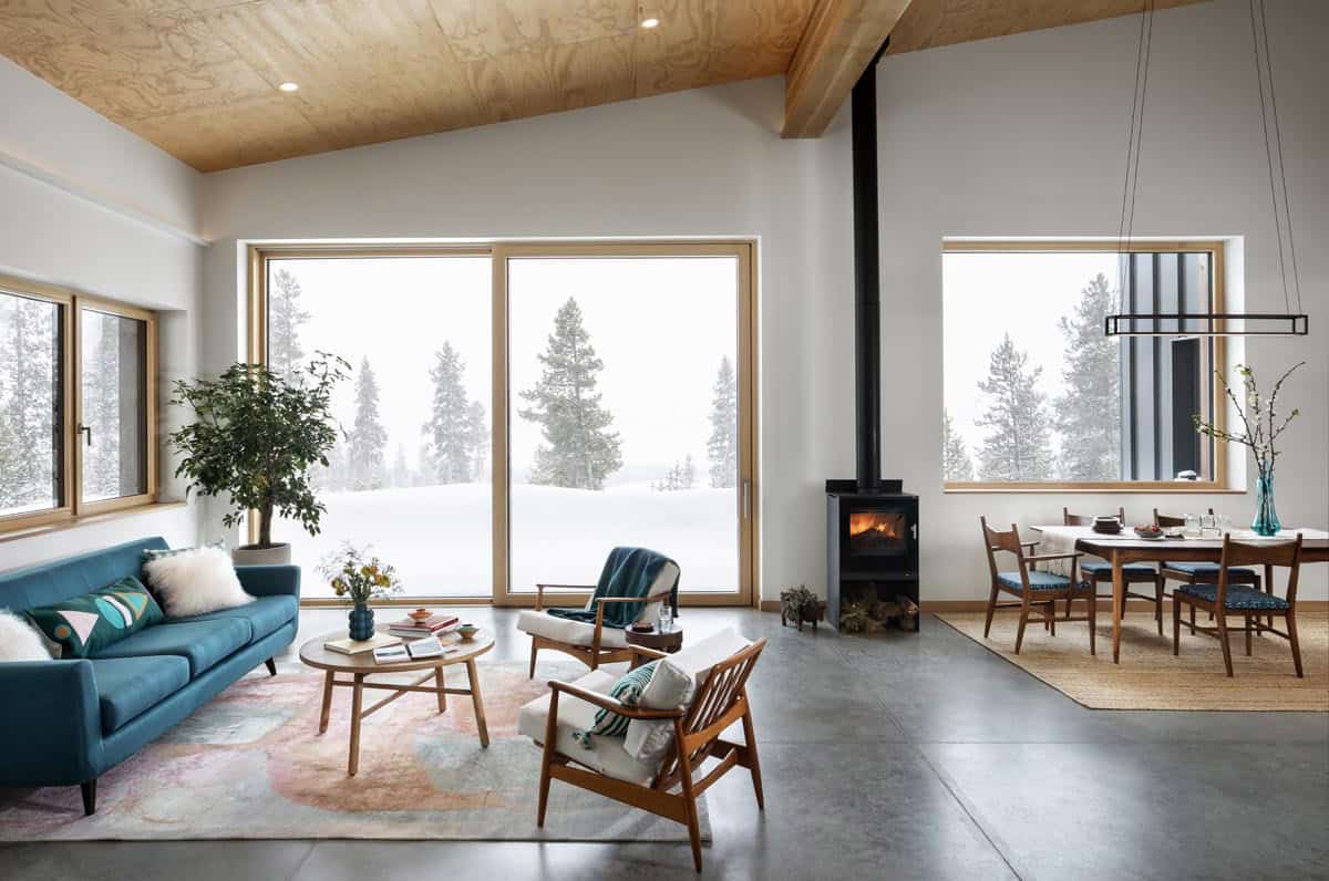 modern living and dining room with a wood fired stove
