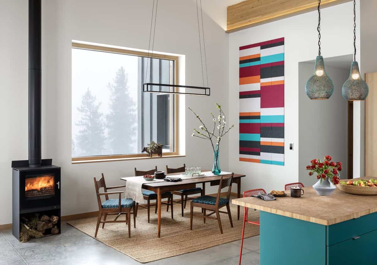 modern dining room and kitchen with a wood fired stove