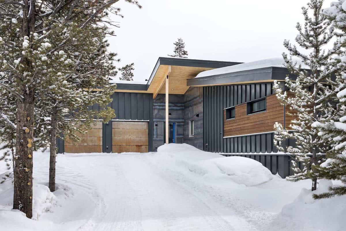 modern mountain home exterior with snow