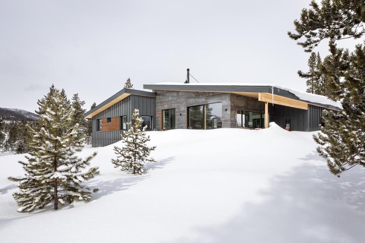 modern mountain home exterior with snow