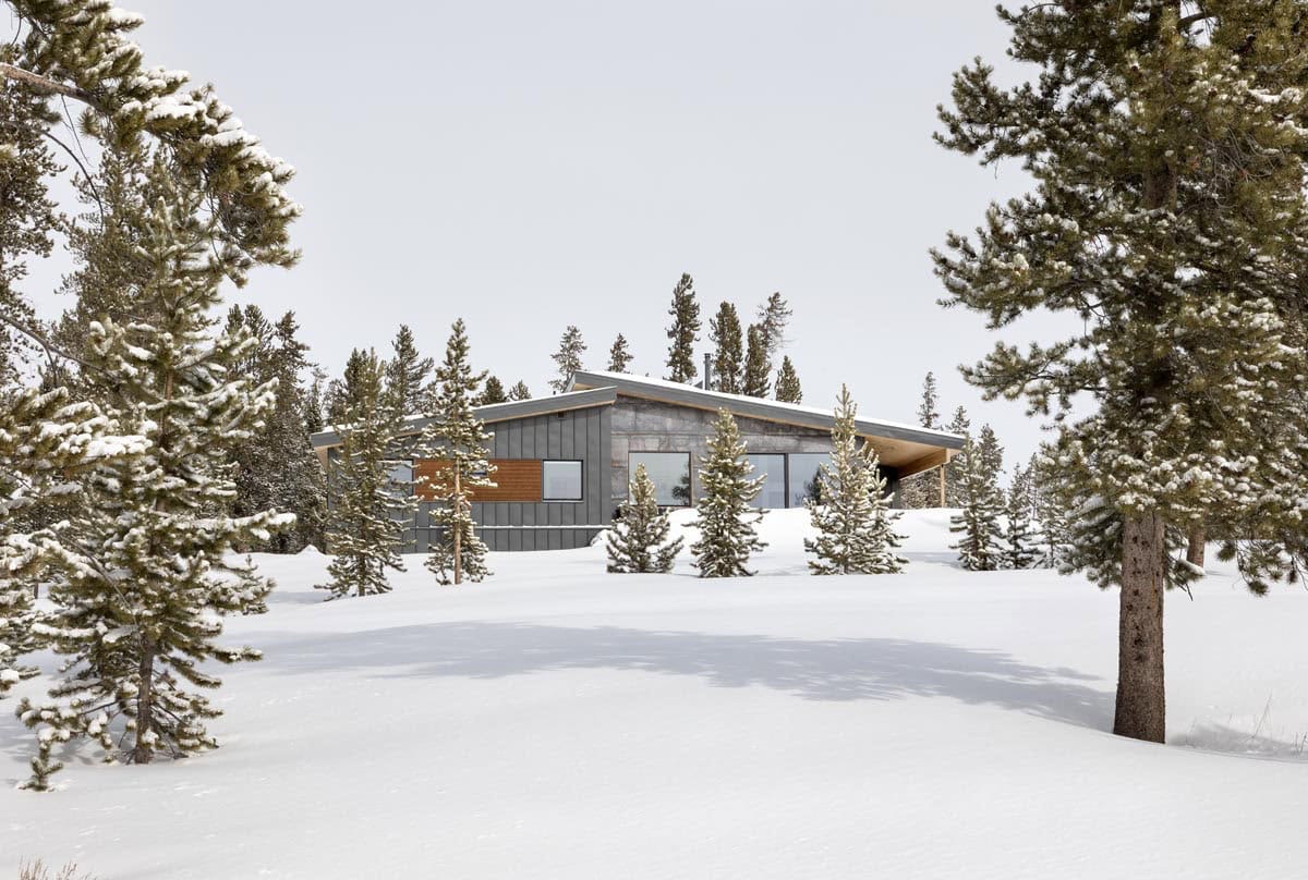 modern mountain home exterior with snow