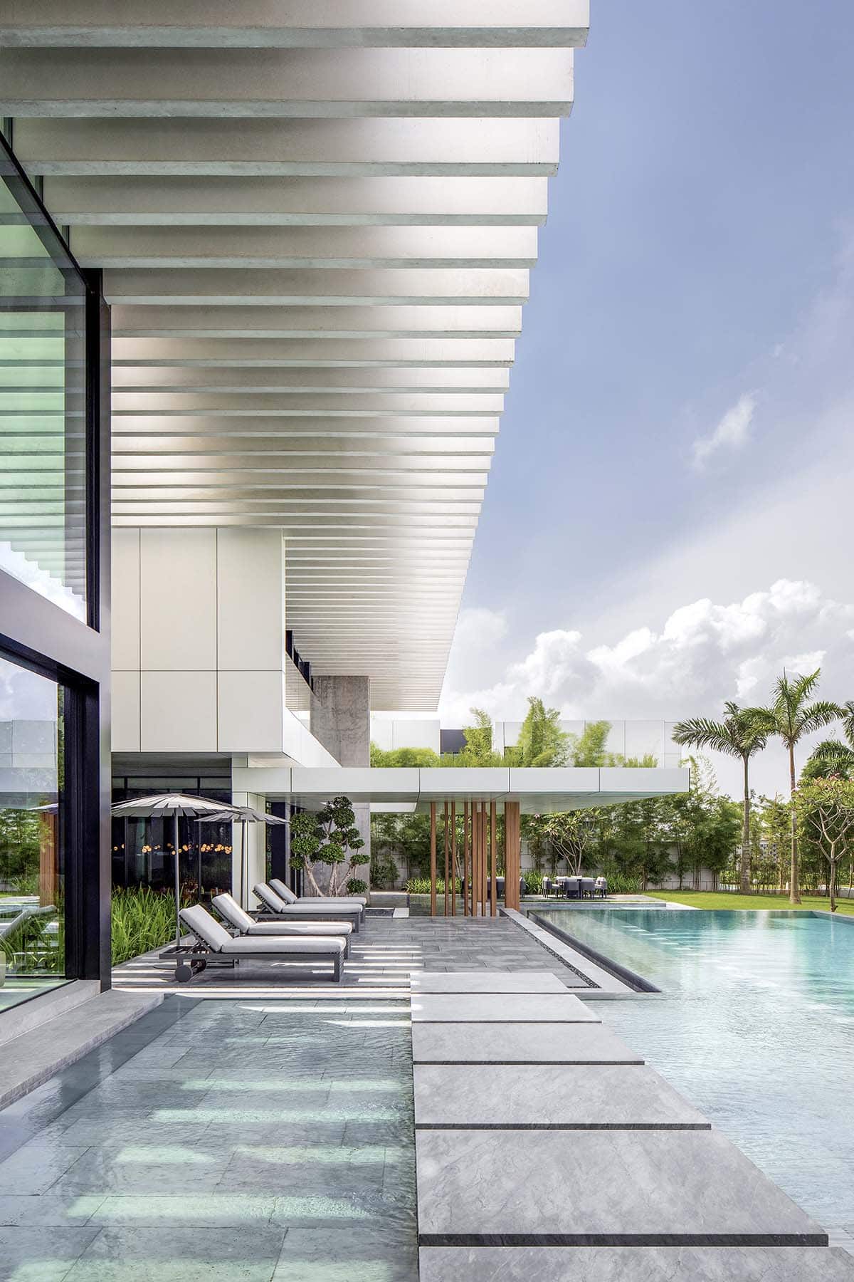 modern waterfront home exterior with a pool