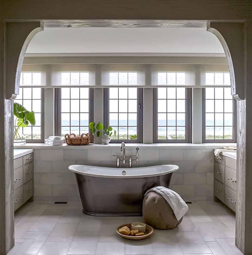 coastal style bathroom with a freestanding tub