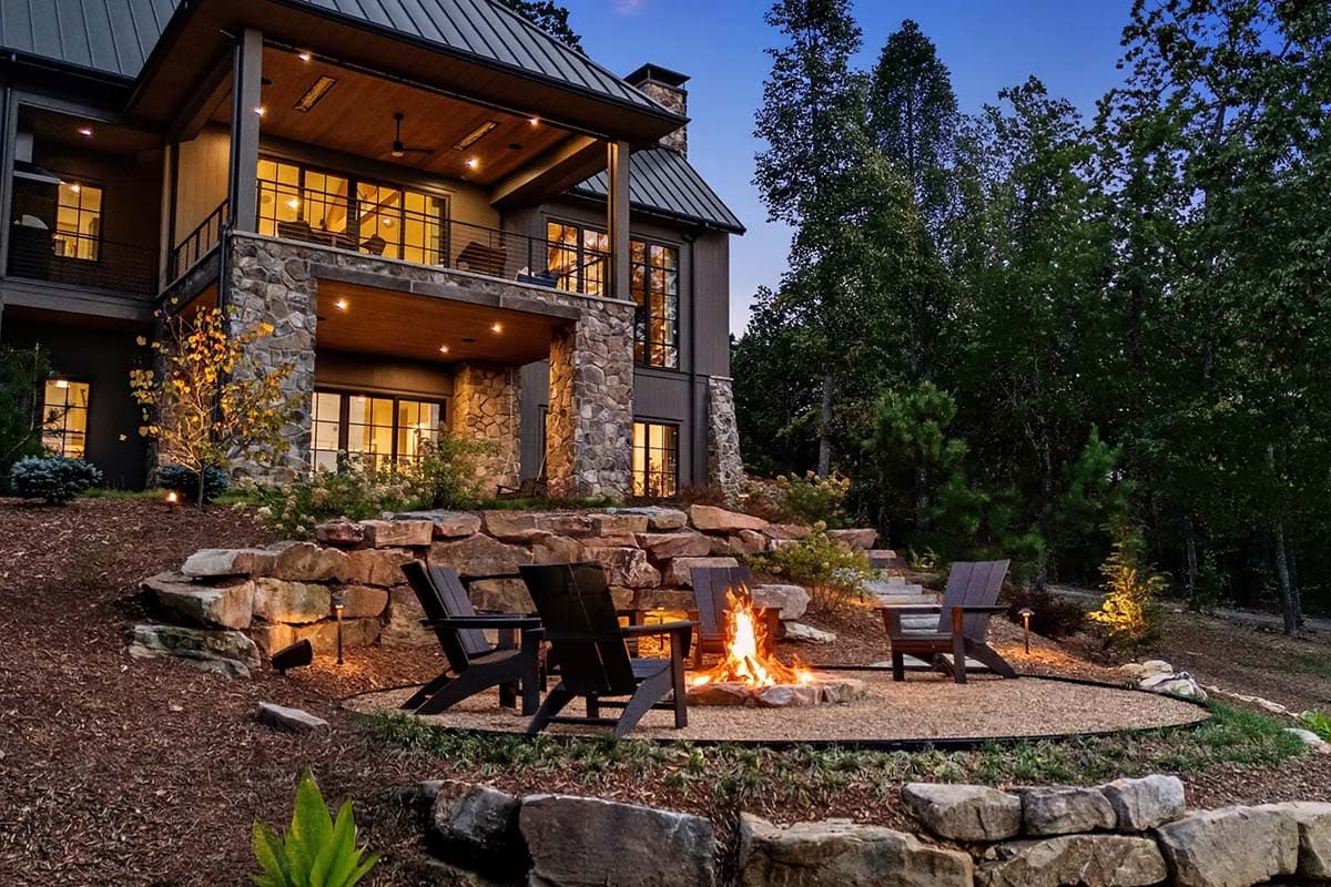 contemporary mountain home exterior backyard at dusk with a fire pit