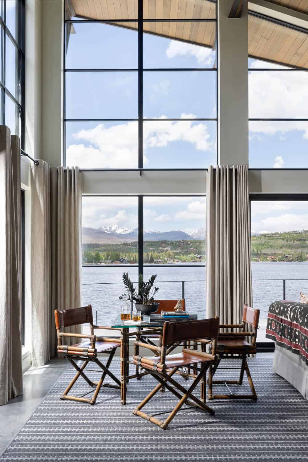 contemporary great room with large windows and lake views