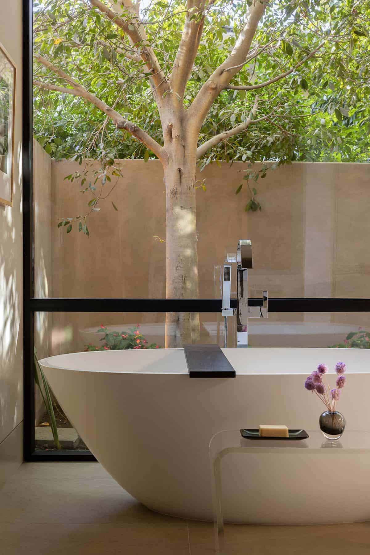 modern bathroom with a freestanding tub and large window