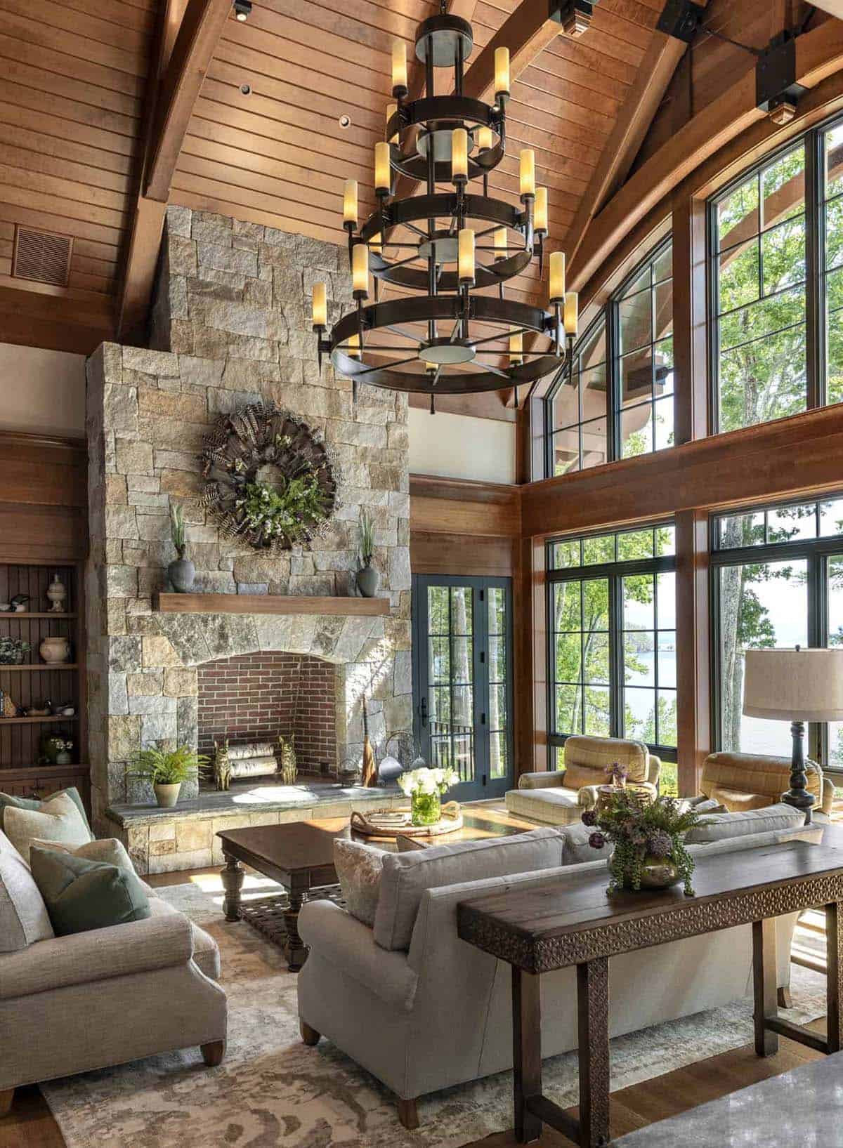 rustic living room with a floor-to-ceiling stone fireplace