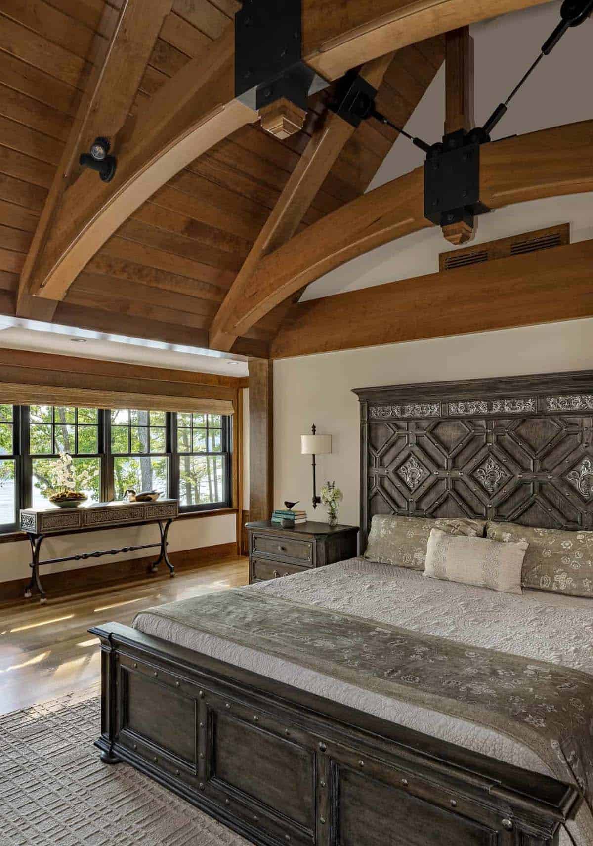 rustic bedroom ceiling trusses and a window