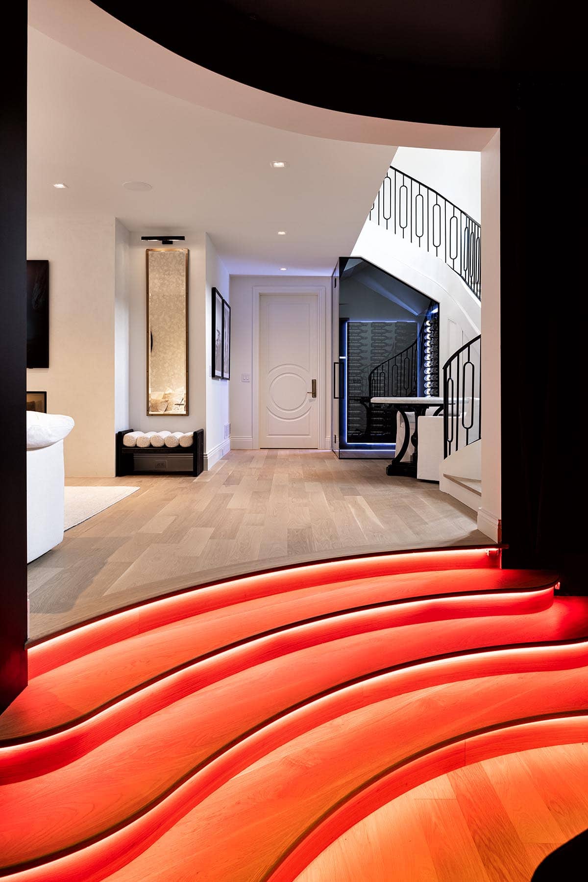 contemporary golf simulator room with led lit staircase