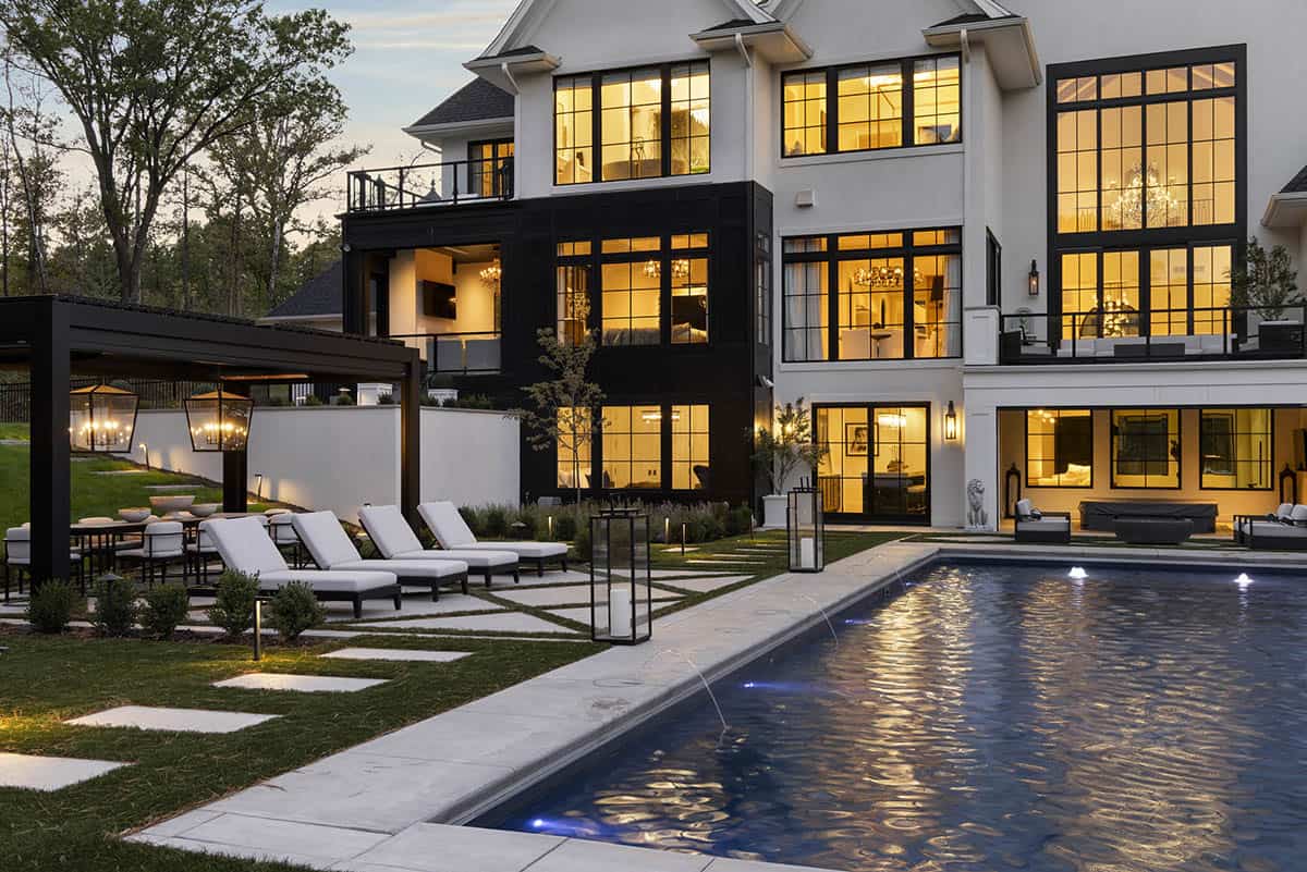 French chateau-inspired home exterior backyard view with a pool