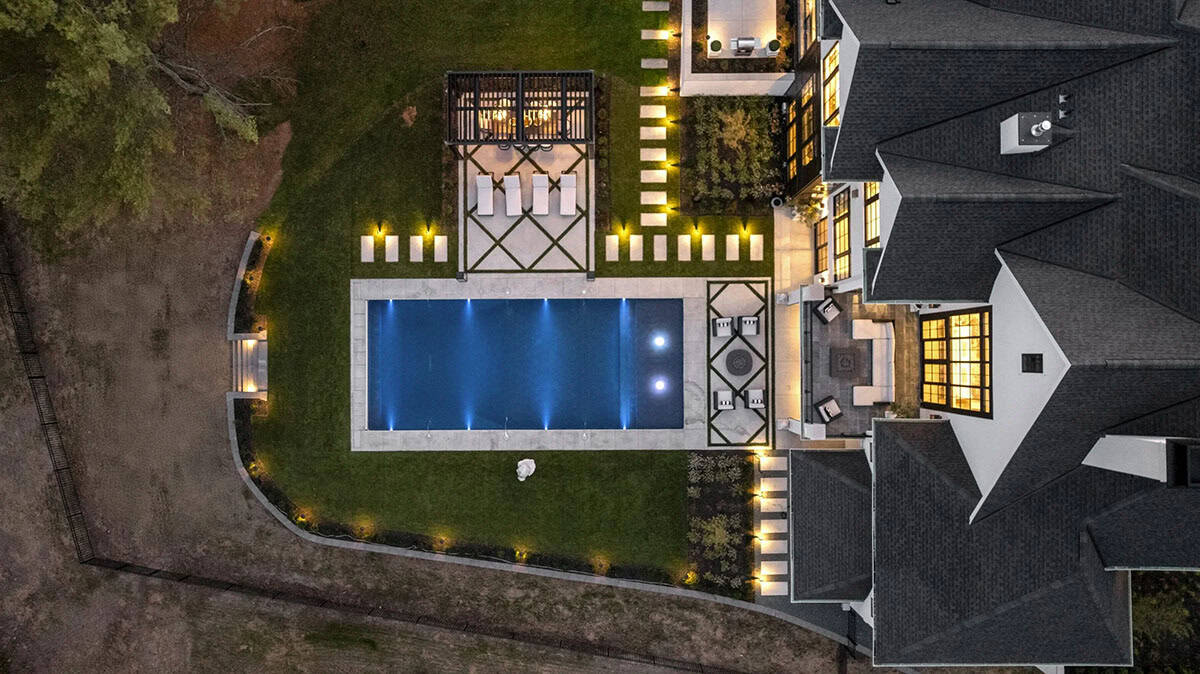 French chateau-inspired home exterior with a pool aerial view 