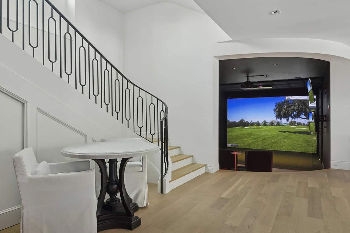 contemporary staircase leading to the golf simulator room