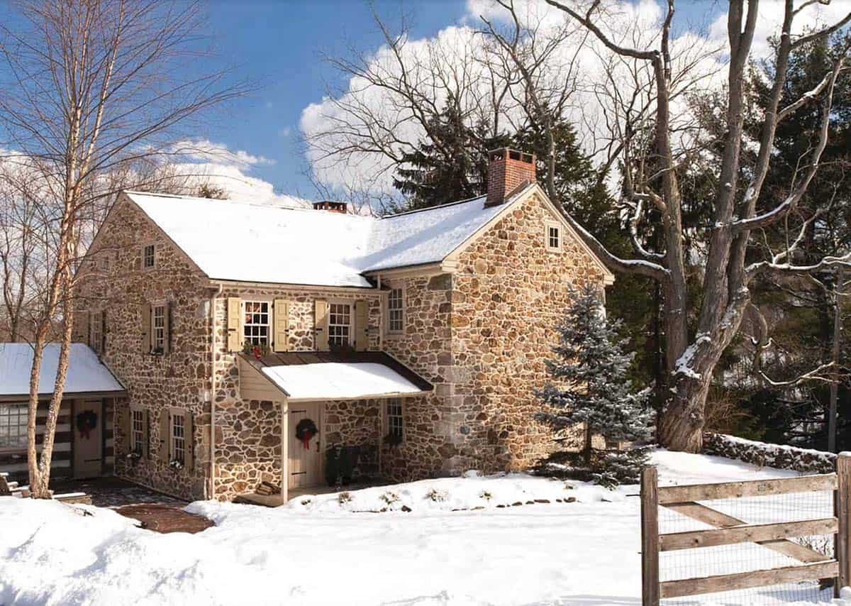stone farmhouse exterior with snow