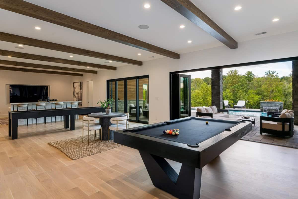 modern lower level family room with a pool table