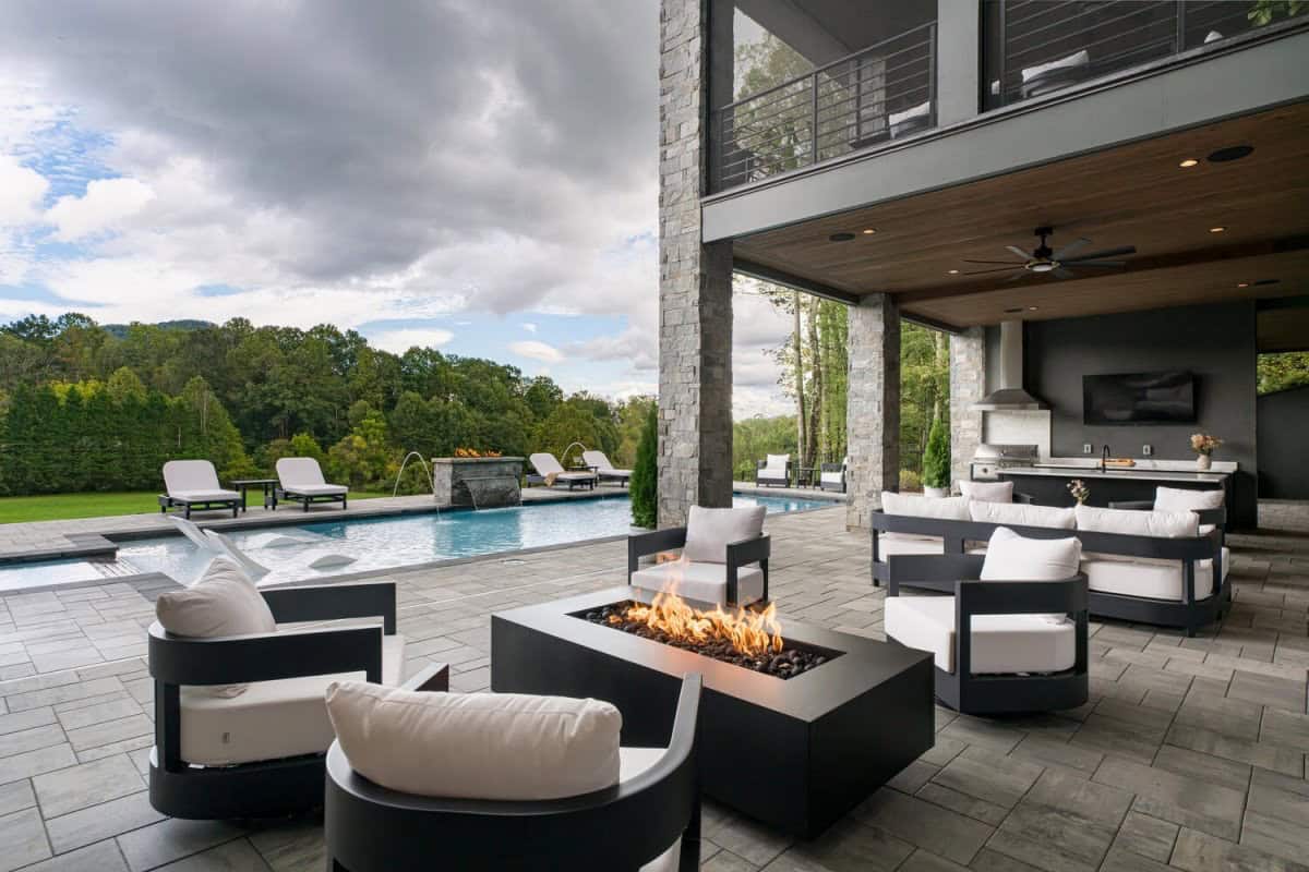 modern mountain home patio with a fire pit