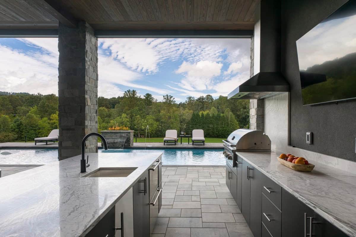 modern mountain home exterior with a covered outdoor kitchen