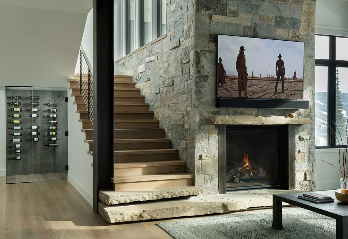 modern lower level family room with a fireplace