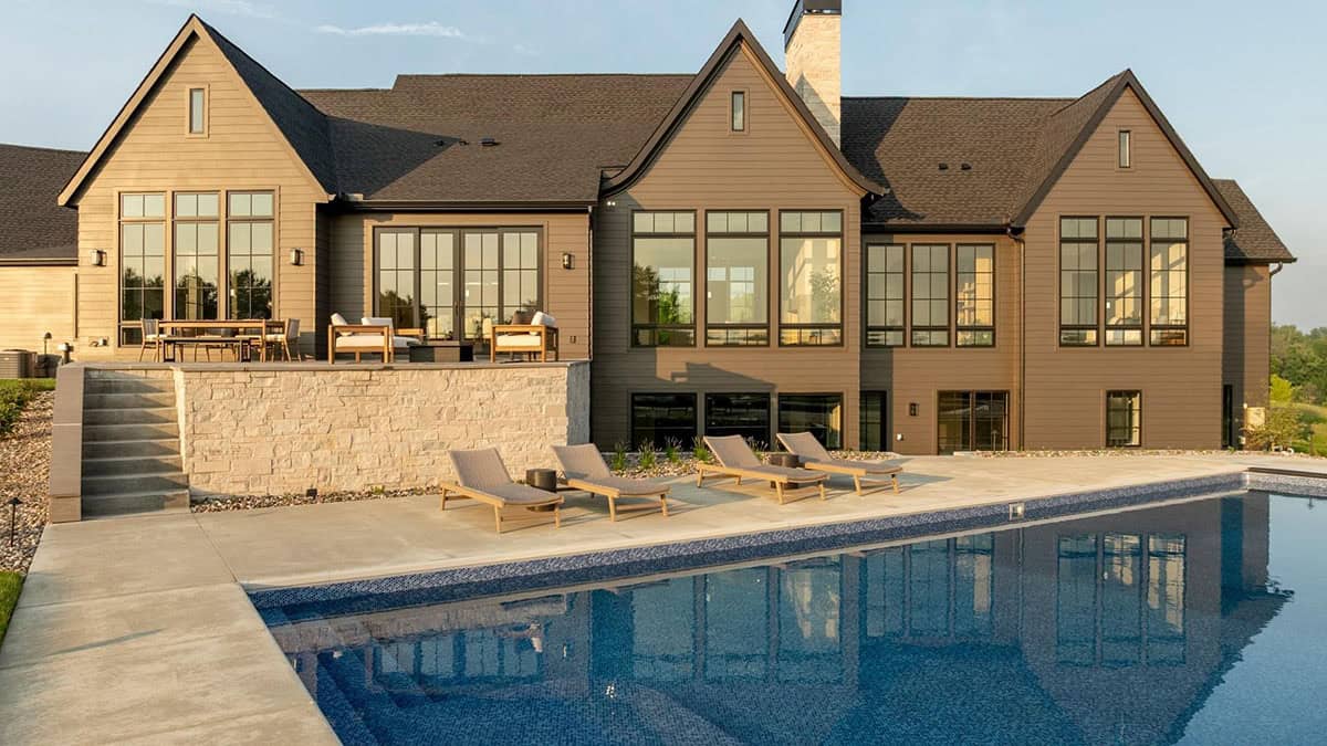 rambler style house exterior with a pool