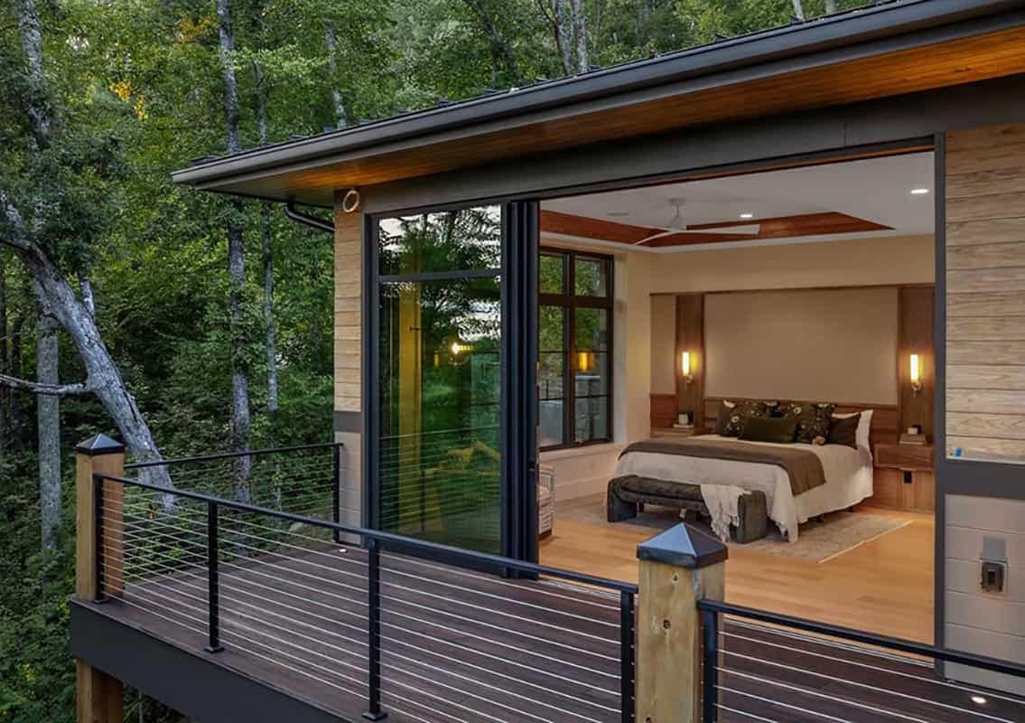modern mountain home exterior with a view of the main bedroom with a private deck