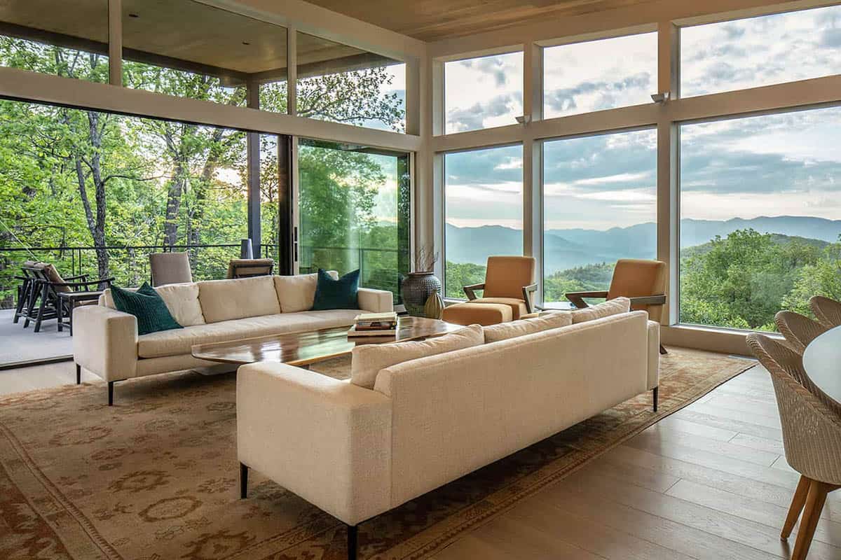 modern living room with large windows and mountain views