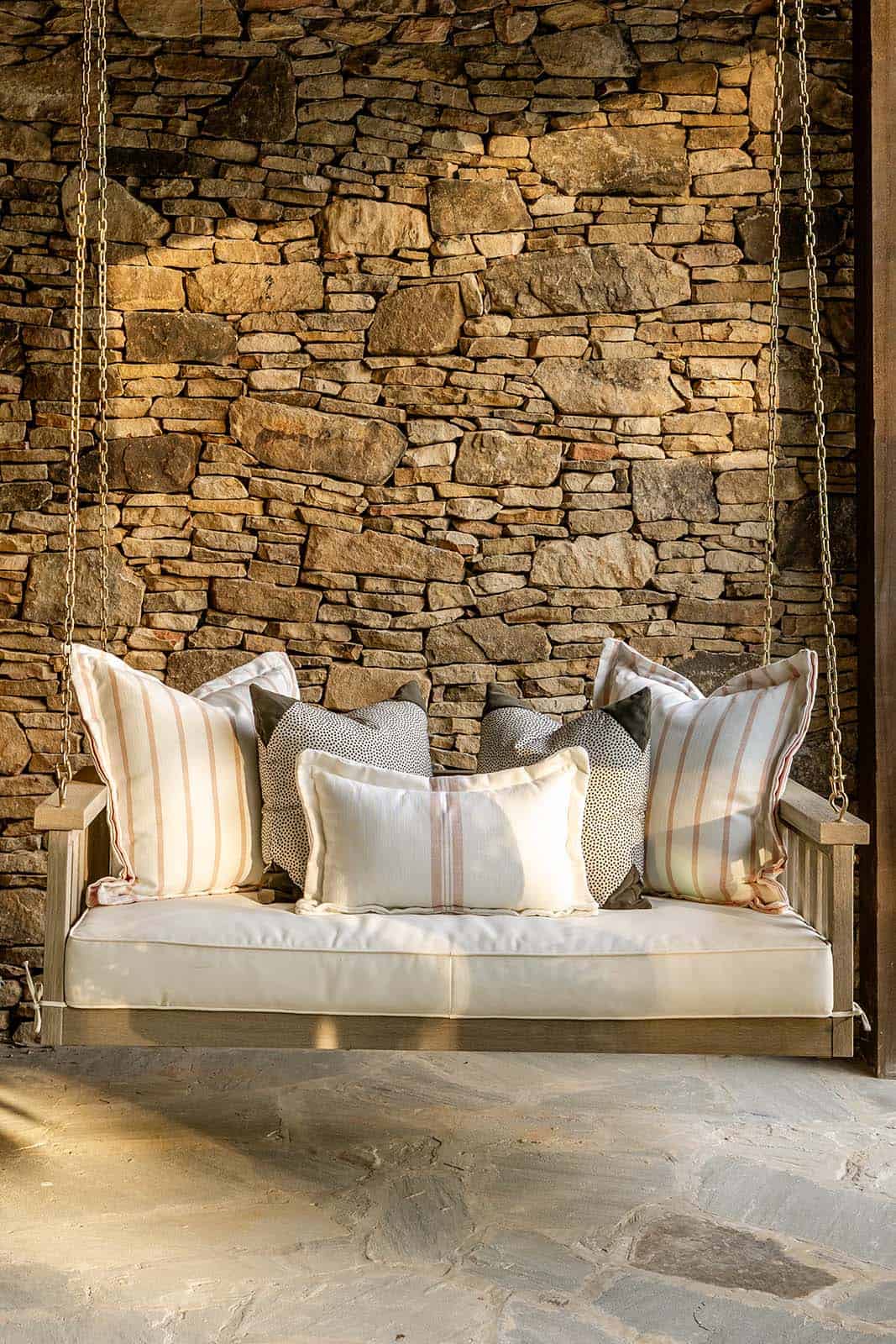 modern rustic mountain house exterior covered porch with a hanging swing