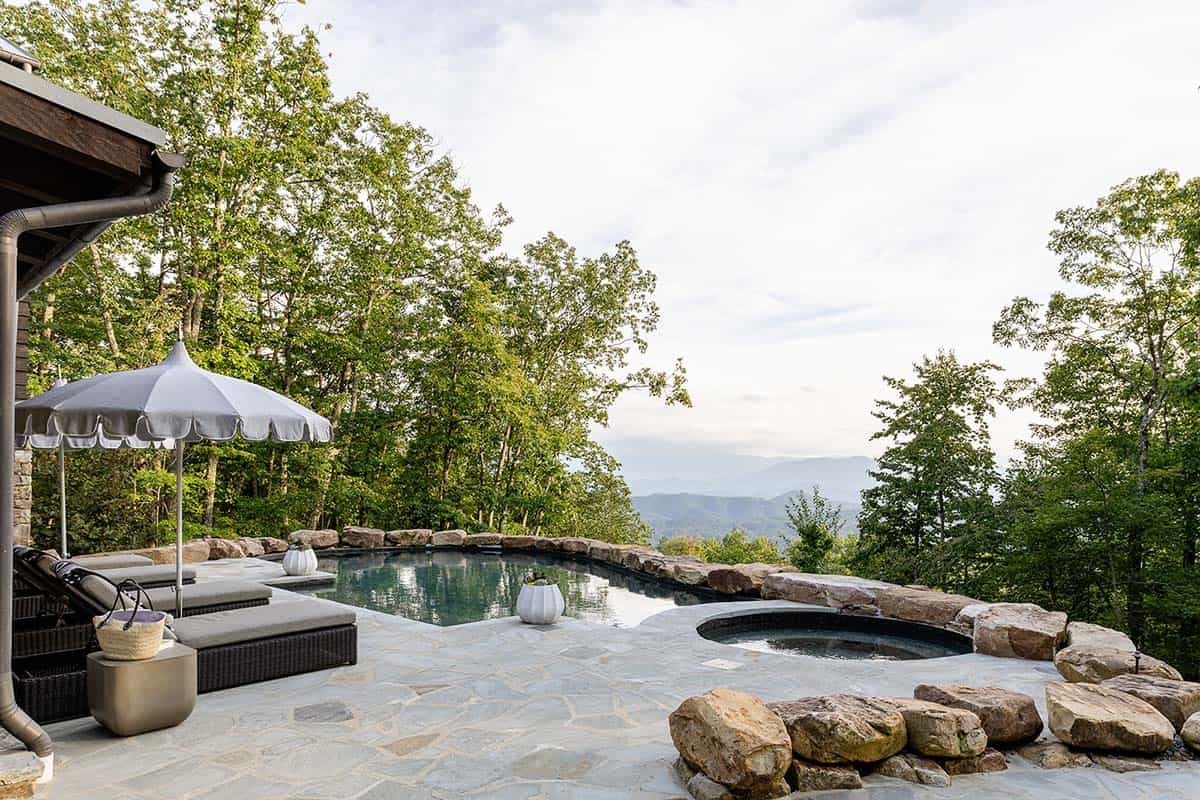 modern rustic mountain house exterior with a pool