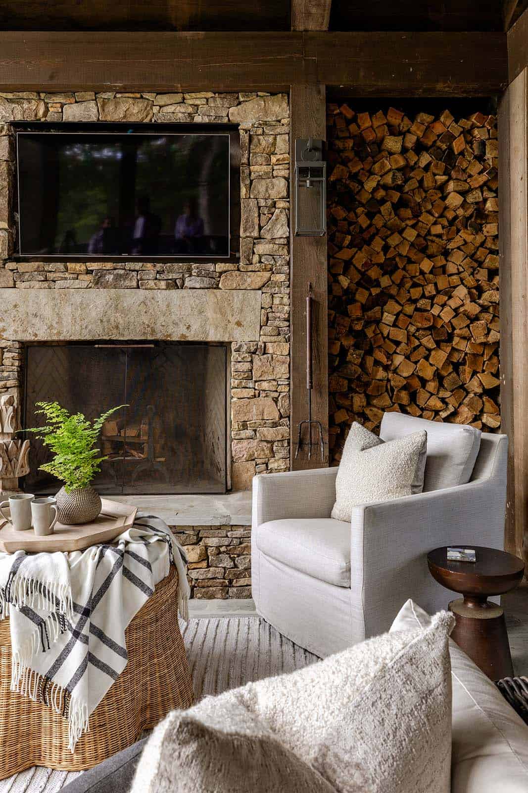 modern rustic mountain house exterior covered porch with a fireplace