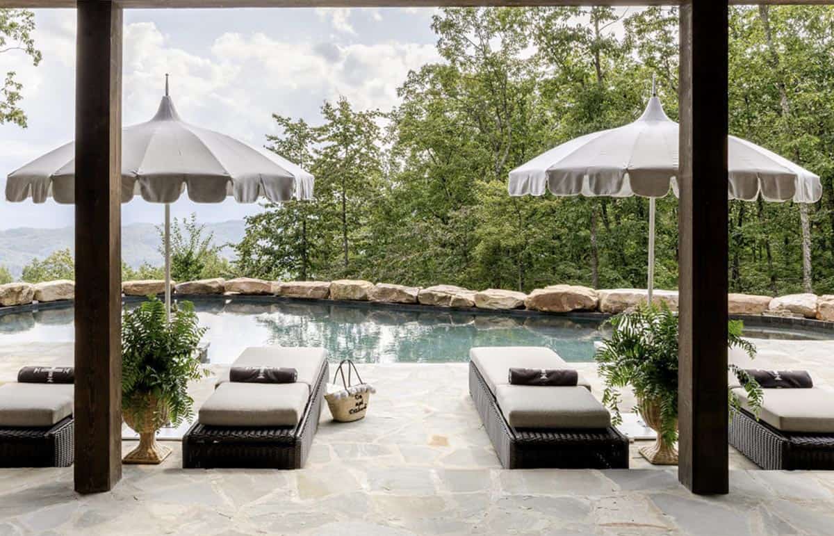 modern rustic mountain house exterior with a pool