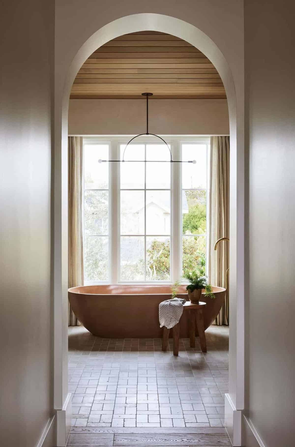 modern spanish style bathroom with a freestanding tub