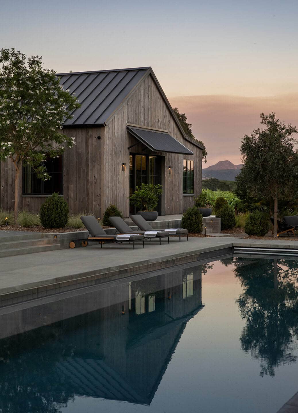 modern farmhouse exterior with a pool