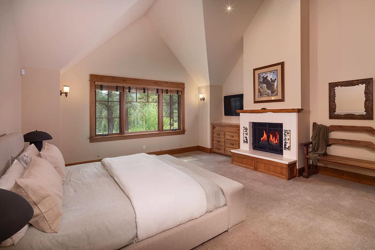 contemporary mountain style bedroom with a fireplace