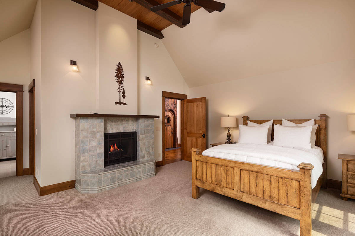 contemporary mountain style bedroom with a fireplace
