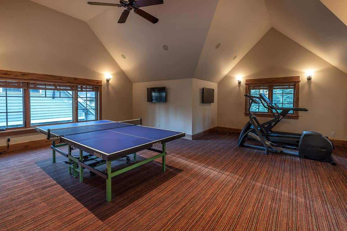 contemporary mountain style home gym with a ping pong table